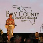 Claire Sherman, 2017 Chairman of the Board, awards Member of the Year Award to Waylon Thompson and Doug Smith.