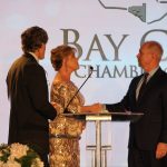 Claire Sherman, 2017 Chairman of the Board, awards Member of the Year Award to Waylon Thompson and Doug Smith.
