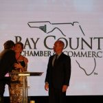 Claire Sherman, 2017 Chairman of the Board, awards Member of the Year Award to Waylon Thompson and Doug Smith.