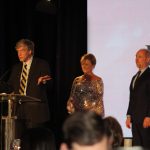 Claire Sherman, 2017 Chairman of the Board, awards Member of the Year Award to Waylon Thompson and Doug Smith.