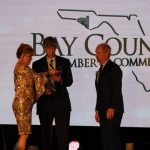 Claire Sherman, 2017 Chairman of the Board, awards Member of the Year Award to Waylon Thompson and Doug Smith.